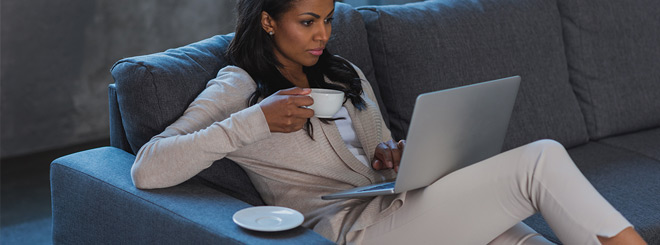 Woman sitting on the couch with laptop